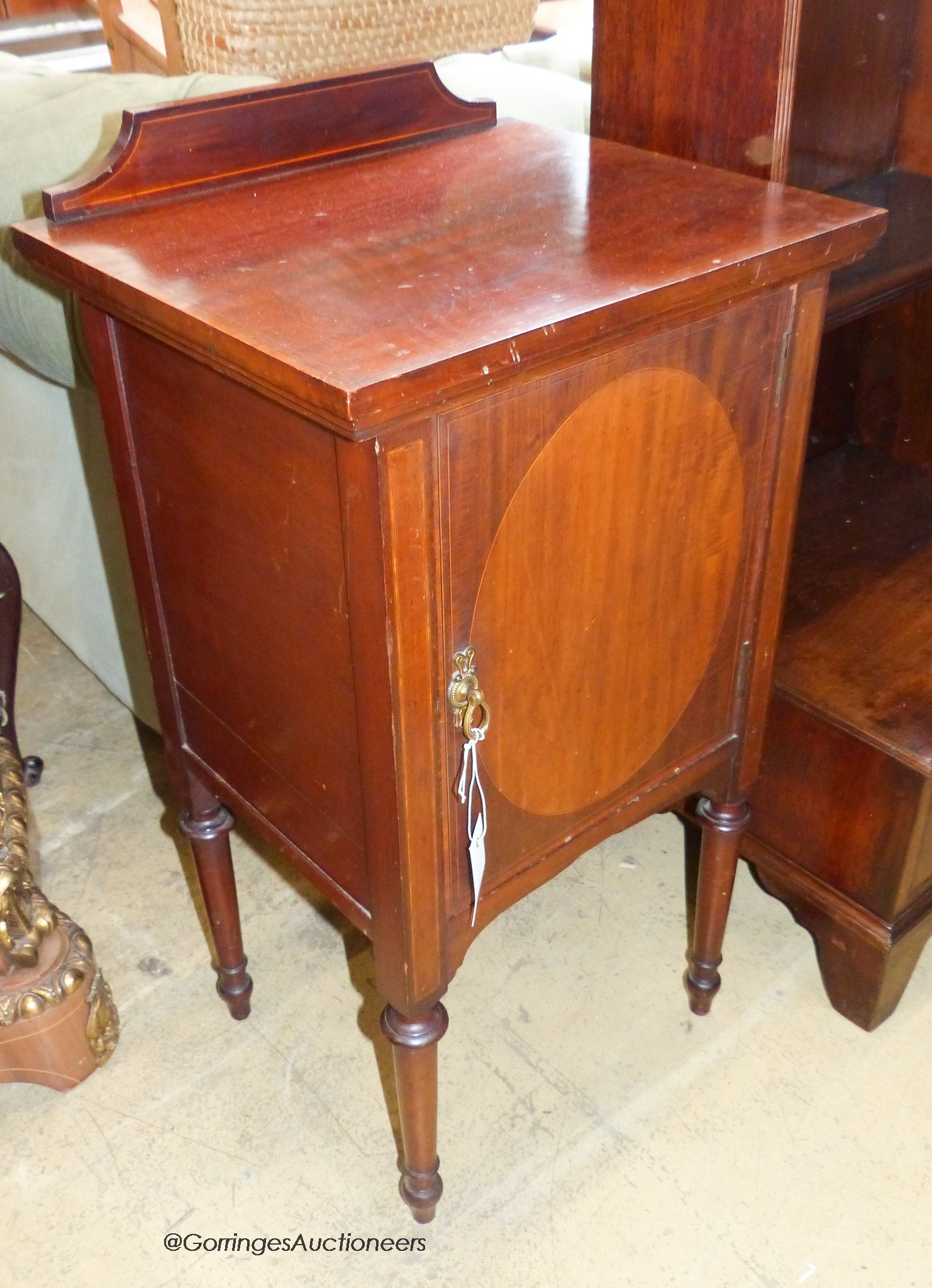 An Edwardian satinwood banded mahogany bedside cabinet. W-43, D-37, H-82cm.